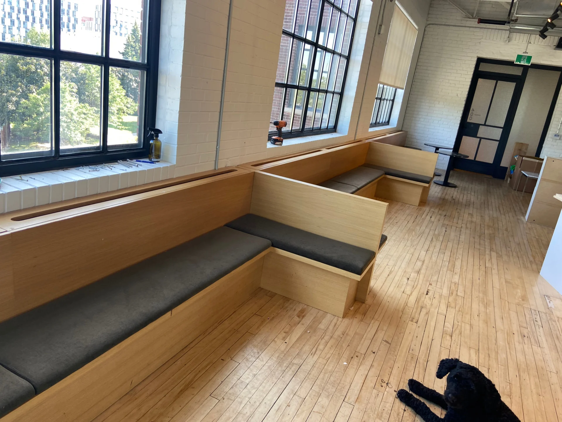 White oak window banquette with stepped corner return. East Room, Toronto