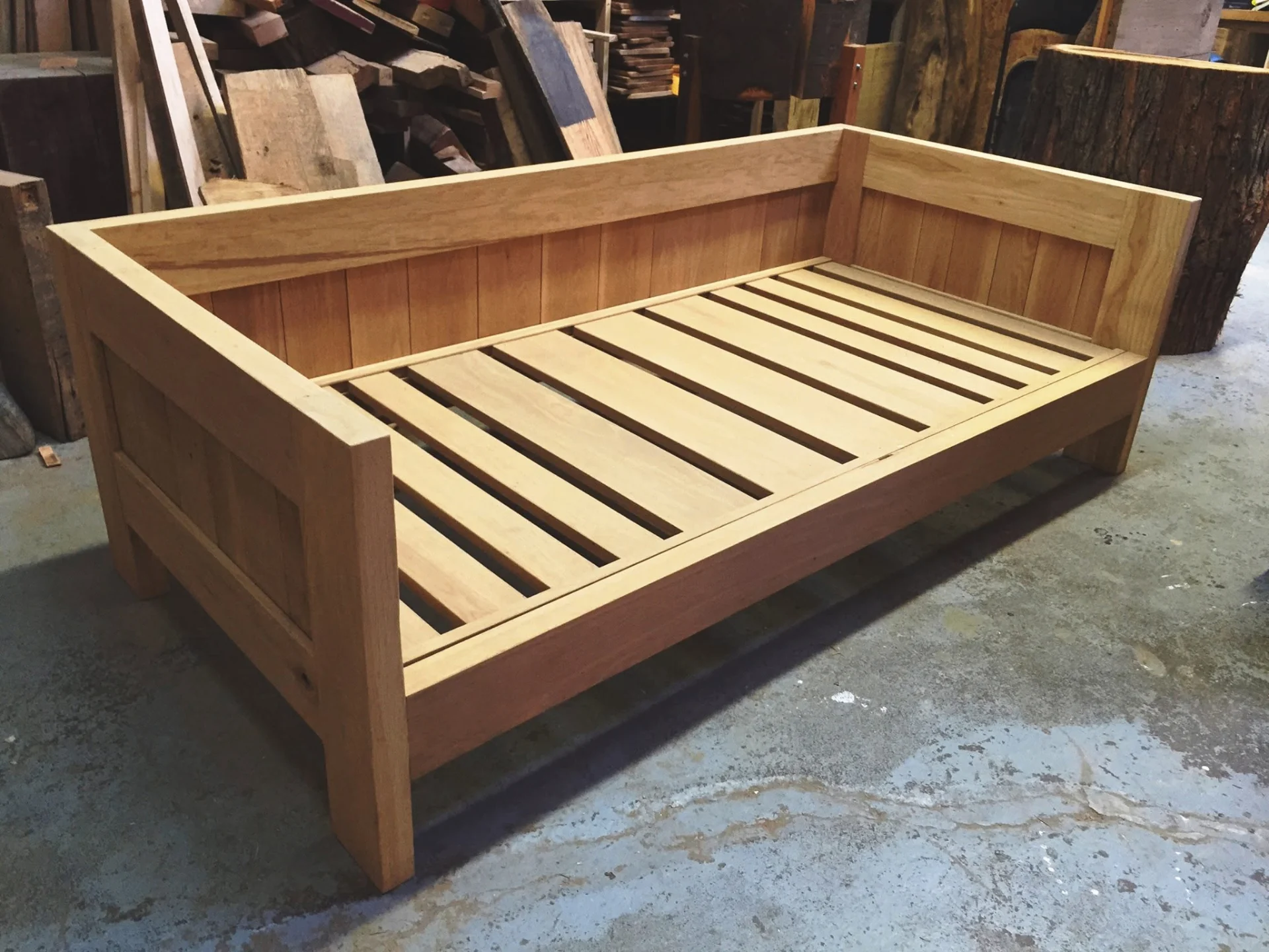 Completed oak daybed frame, three-quarter view. East Room, Toronto