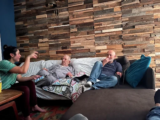 Reclaimed offcut feature wall with three people on the couch